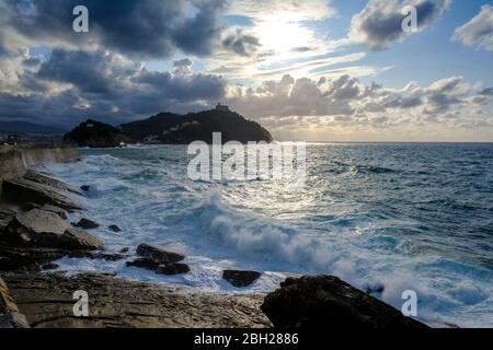 Spain, Gipuzkoa, San Sebastian, Clouds over coastline of Bay of Biscay with hill in background Stock Photo