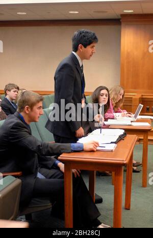 Austin Texas USA: Teen 'lawyers' argue a case as Texas high school students participate in mock court hearings as part of YMCA Youth in Government program at the State Capitol. Students learn the legal profession by acting out trials in competition with their peers. ©Bob Daemmrich Stock Photo
