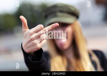 Angry young woman giving the finger, close-up Stock Photo