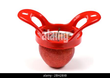 Red device for slicing apples isolated on white background. High resolution photo. Full depth of field. Stock Photo