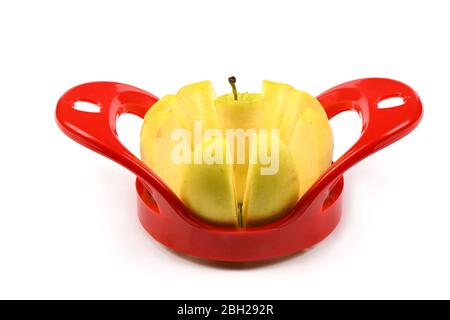 Red device for slicing apples isolated on white background. High resolution photo. Full depth of field. Stock Photo