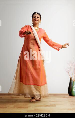 Beautiful kathak dancer performing at home. Stock Photo