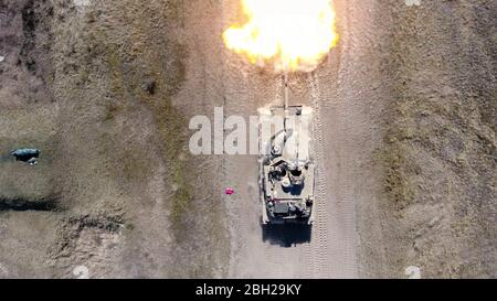 U.S. Army soldiers with the 2nd Armored Brigade Combat Team fire a shell from a M1 Abrams tank canon during proficiency training at Konotop Range April 18, 2020 in Drawsko-Pomorskie Training Area, Poland. Stock Photo