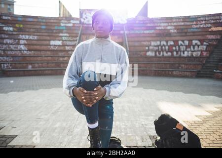 Young woman warming up in a skate park Stock Photo