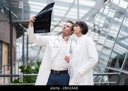 Two doctors looking at x-ray images Stock Photo