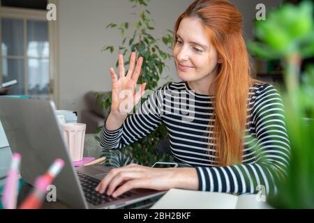 Young woman having a video conference at home Stock Photo