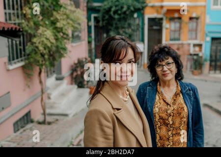 Portrait of smiling woman and her mother in the background on the street, Istanbul, Turkey Stock Photo