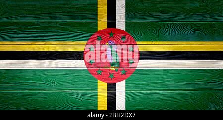 Dominica flag painted on old wood plank background. Brushed natural light knotted wooden board texture. Wooden texture background flag of Dominica. Stock Photo