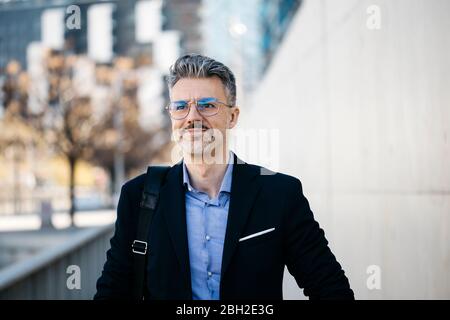 Portrait of confident gray-haired businessman in the city Stock Photo
