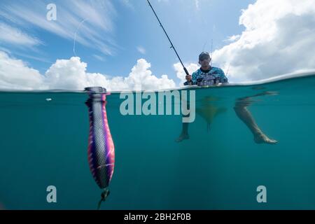 Split shot of man in a kayak fishing with a lure Stock Photo