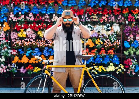 Portrait of bearded man with fixie bike wearing mirrored sunglasses Stock Photo