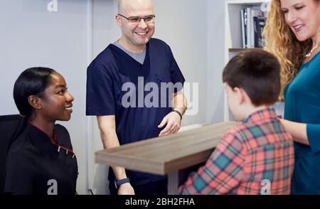 People at reception desk of a dental practice Stock Photo