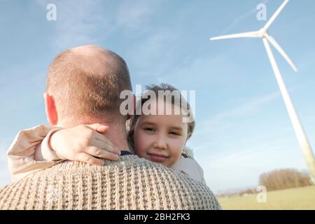 Portrait of little girl on her father'S arms in nature Stock Photo