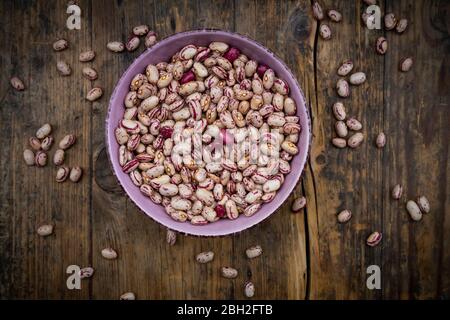 Bowl of dried pinto beans in bowl Stock Photo