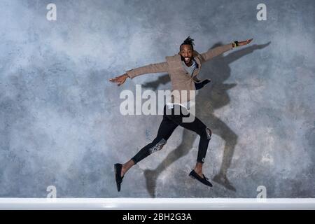 Portrait of young man jumping and dancing Stock Photo