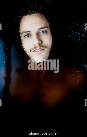 Portrait of young man with blue eyes  in water Stock Photo