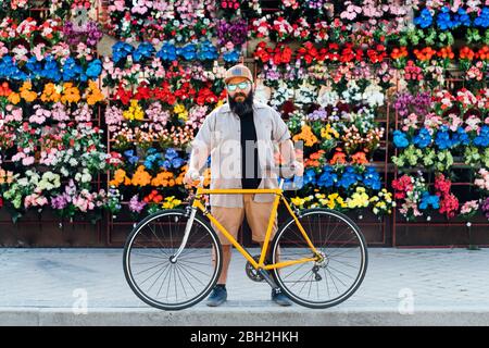 Portrait of bearded man with fixie bike wearing mirrored sunglasses Stock Photo