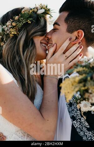 Happy bridal couple kissing each other Stock Photo