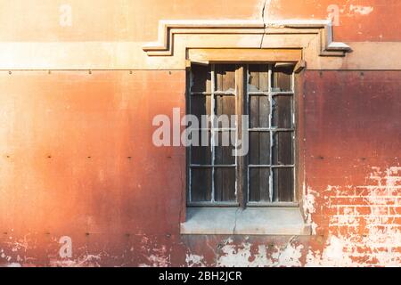 Shuttered window in old brick wall Stock Photo
