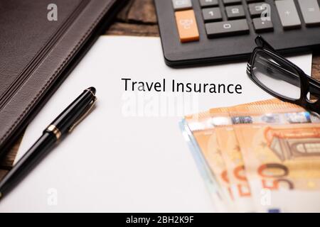 Travel Insurance text on Document and gavel isolated on wooden office desk close up Stock Photo