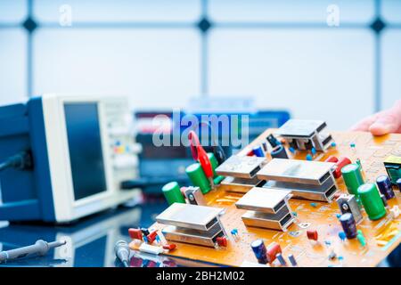 Debugging electronics device. PCB witch microcontroller in electronics laboratory Stock Photo
