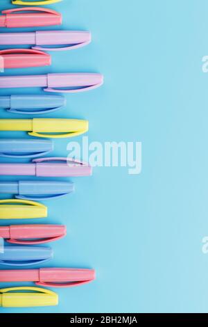Multi-colored markers on a blue background with free space. Stock Photo