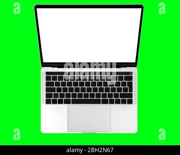 Laptop computer keyboard with white screen isolated on green background Stock Photo