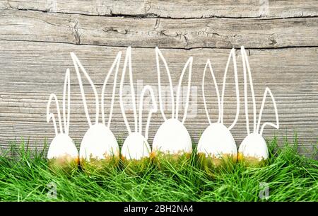 Easter decoration background. Easter eggs in green grass. Vintage style toned picture Stock Photo