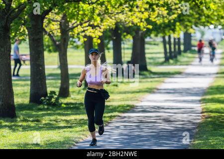 London, UK. 23rd Apr, 2020. Clapham Common is reasonably busy as the sun is out and it is warmer. The 'lockdown' continues for the Coronavirus (Covid 19) outbreak in London. Credit: Guy Bell/Alamy Live News Stock Photo