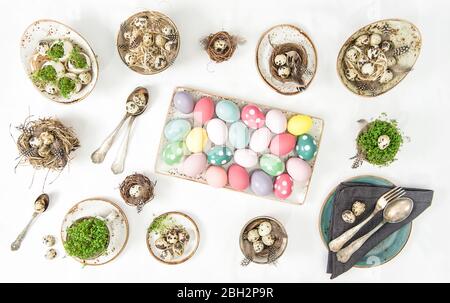 Easter flat lay. Festive table place setting decoration with colored eggs Stock Photo