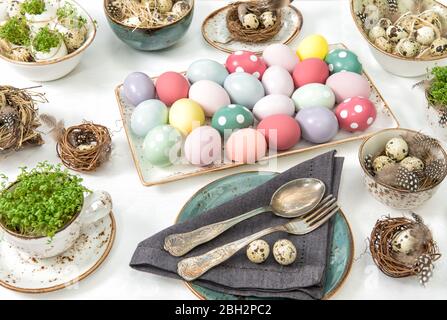 Easter decoration with colored eggs. Festive table place setting Stock Photo