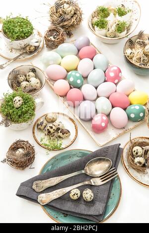 Easter still life. Festive table place setting decoration with colored eggs Stock Photo