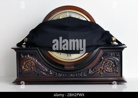 Home watch and protective mask in black fabric. Prevent Coronavirus, COVID-19. Stock Photo