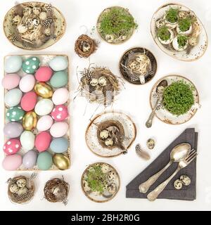 Easter flat lay top view. Festive table place setting decoration with colored eggs Stock Photo