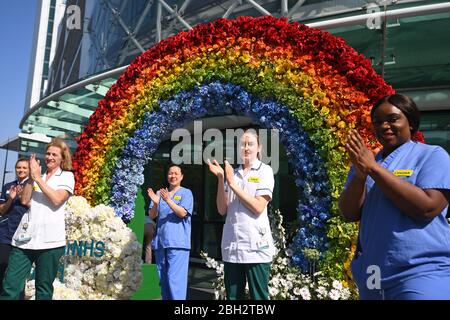 Nurses and occupational therapists help to unveil a rainbow floral displays at University College Hospital at Euston Road, in London to thank the public for their support during the ongoing pandemic. Stock Photo