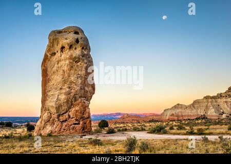 Moon over Chimney Rock at dawn, Bryce Canyon formation in far distance, Kodachrome Basin State Park, Utah, USA Stock Photo
