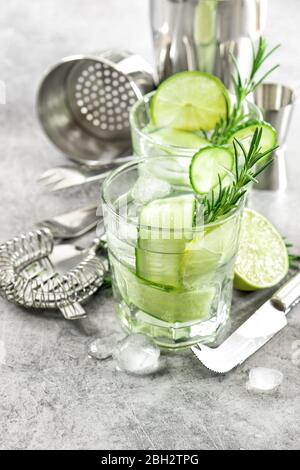 Drink with cucumber, lime, ice and rosemary Stock Photo