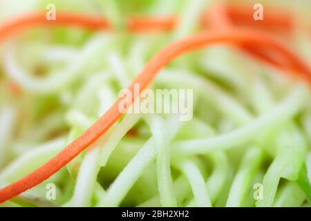 Healthy eating concept. Fresh vegetable salad of sliced thin strips of carrot and zucchini extreme close-up. Stock Photo