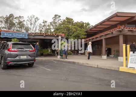 People wait in line to enter a Whole Foods Market supermarket while observing social distancing requirements during an outbreak of the COVID-19 coronavirus in Lafayette, California, March 29, 2020. () Stock Photo