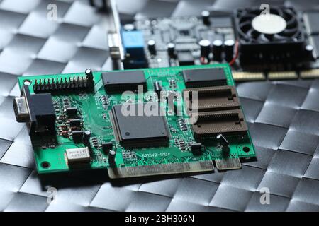 Old green computer chip and old video card on a grey table Stock Photo