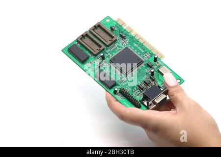 woman hand holding green computer chip isolated on a white background Stock Photo