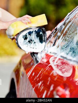 Woman washing her car Stock Photo