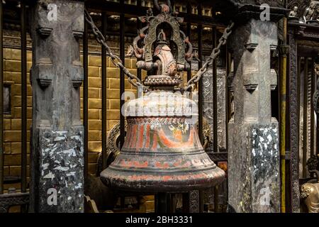 Old bronze bell in a Buddhist temple. Stock Photo