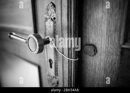 BW shallow depth of field (selective focus) details with a broken wax seal on an old massive wooden door. Stock Photo