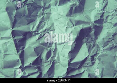 A crumpled paper background. Light green color. Stock Photo