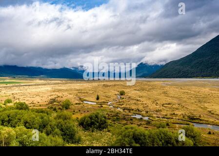Mountain, hills, plains, meadows, prairie, fields and river flowing. Waimakariri river valley, near Arthur's Pass and Lake Pearson, New Zealand. Stock Photo
