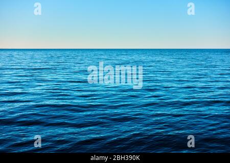 Panoramic view with rippled deep blue sea water, horizon and sky, may be used as background Stock Photo