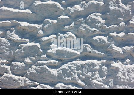 Texture of stonework covered by white stucco close-up, may be used as background Stock Photo