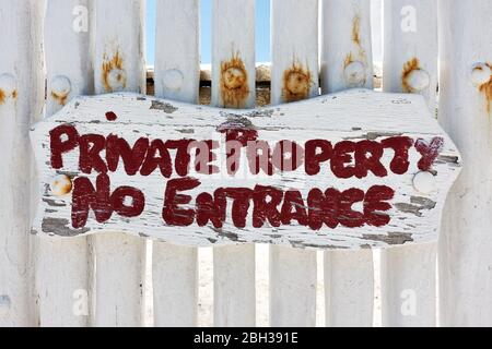 Private property No entrance sign on white wooden fence Stock Photo