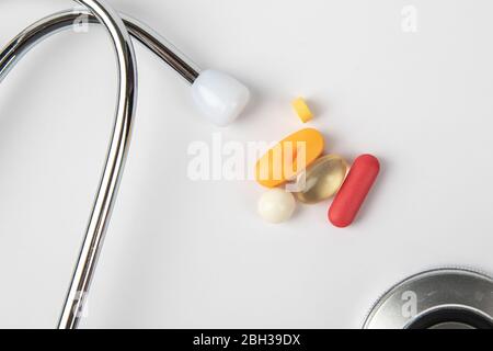 A picture of stethoscope, medicines and clock. It is for medical reminder. Stock Photo